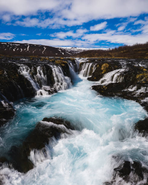 istock Bruarafoss waterfall with stunning turquoise waters under a bright sky in south Iceland 2194061261