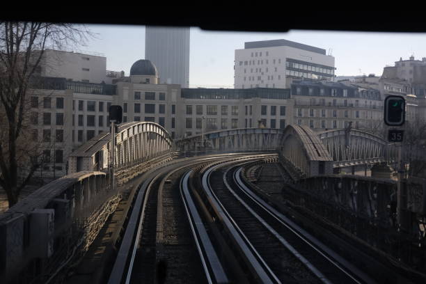 Paris, France - February, 13, 2025: Numerous railway tracks at the arrival of a station with colorful graffiti on the buildings at Gare Saint-Lazare in Paris, France