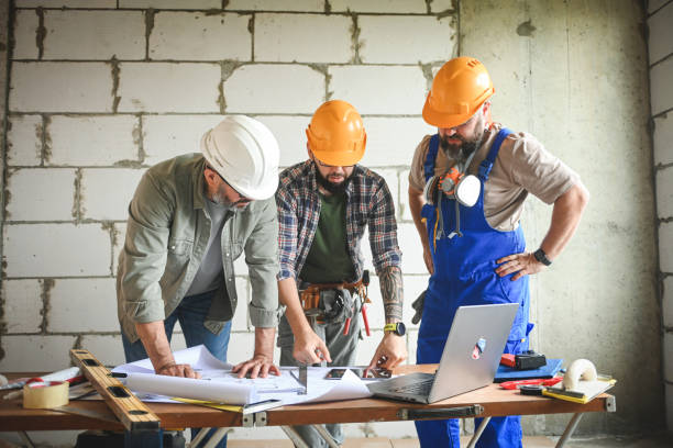 istock a team of builders, construction team is doing repairs in a new house 2194061943