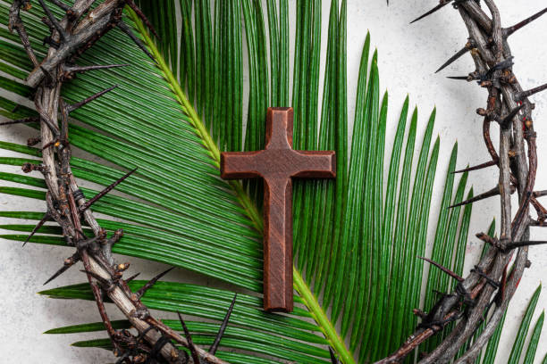 istock Palm Sunday. Crown of thorns, cross on palm leaf 2194062009