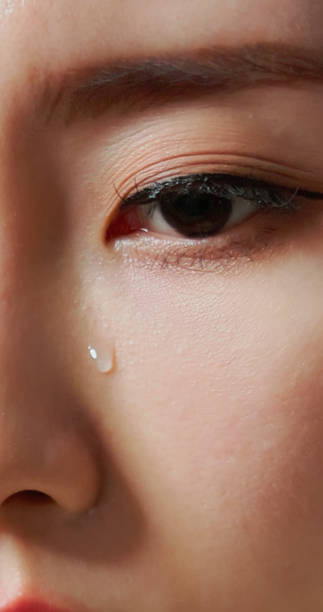 istock tears rolling down woman eye 2194063460