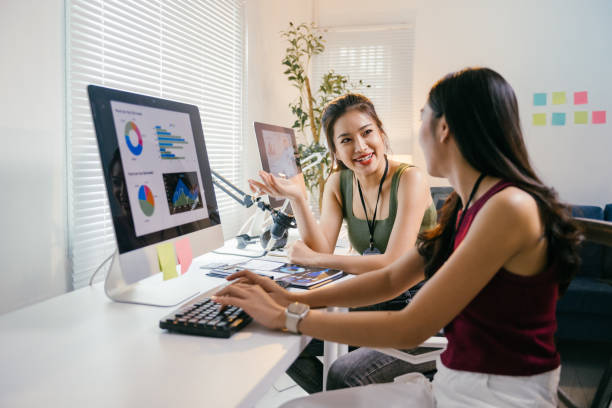 istock Two young asian businesswomen are collaborating on a project, analyzing data displayed on a computer screen in a modern office, engaging in a productive discussion and demonstrating teamwork 2194064518