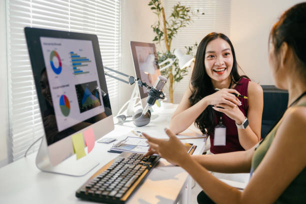 istock Two young asian businesswomen are discussing charts displayed on a computer screen in a modern office, collaborating on a project and sharing their insights with smiles 2194064528