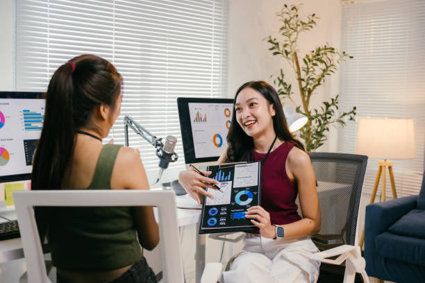istock Two young businesswomen collaborating in a modern office, discussing charts and graphs while analyzing data together for their project, showcasing effective teamwork and communication 2194064560