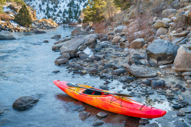 istock whitewater kayak with a paddle on a river shore  - Arkansas River, Colorado in winter scenery 2194065024