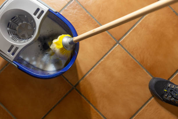 istock Janitor cleaning floor with mop and bucket 2194065584