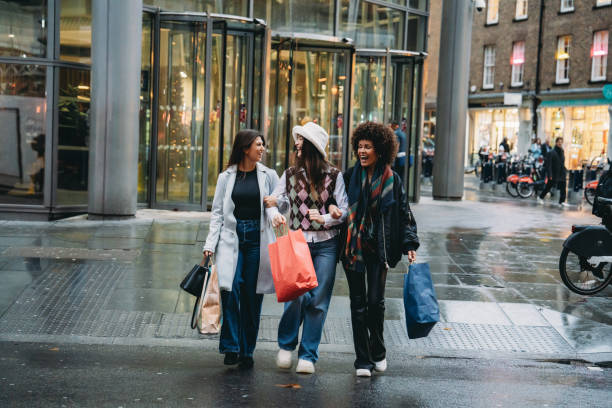 istock Three young women walking and talking after shopping spree 2194066915