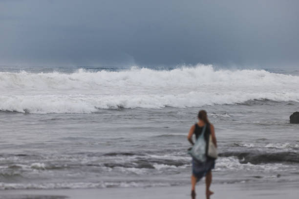 A woman is walking on beach after swimming.Canggu beach - Bali Island - Indonesia.