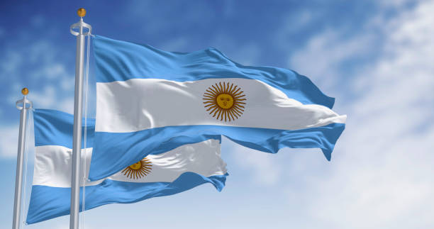 istock Two Argentina national flags waving on a clear day 2194070111