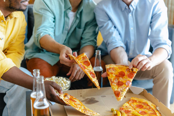istock Friends dining together enjoying pizza and beverages during a fun gathering 2194071398