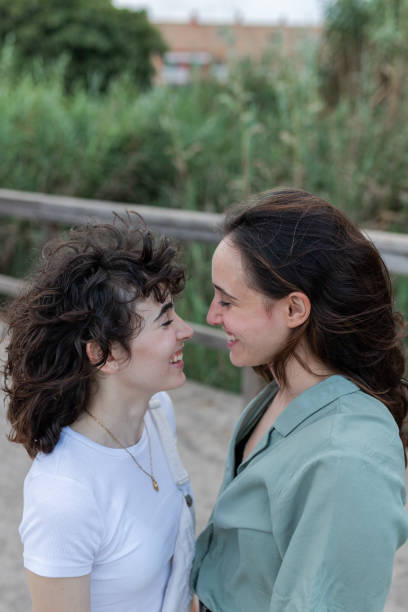 istock Lesbian couple interacting on bridge in daytime 2194072074