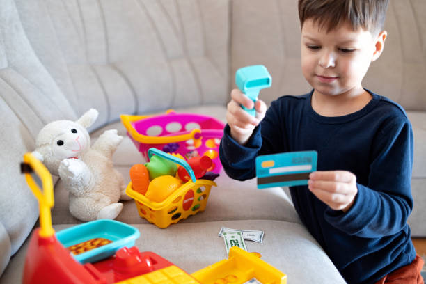 istock A child plays store with a toy cash register. 2194072084