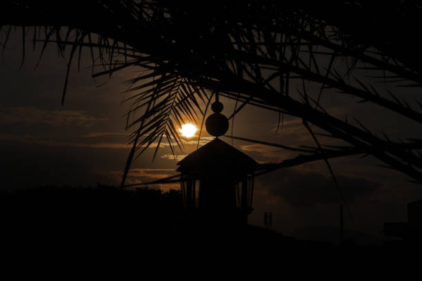 Twilight atmosphere at the Baiturrahman Grand Mosque, Banda Aceh City, Aceh Province, Indonesia. Residents who came took photos in the mosque yard. You can also see the sunset from between the umbrella poles in the mosque yard.