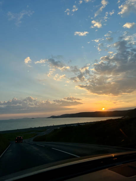 istock Seascape sunset with road by car 2194074660