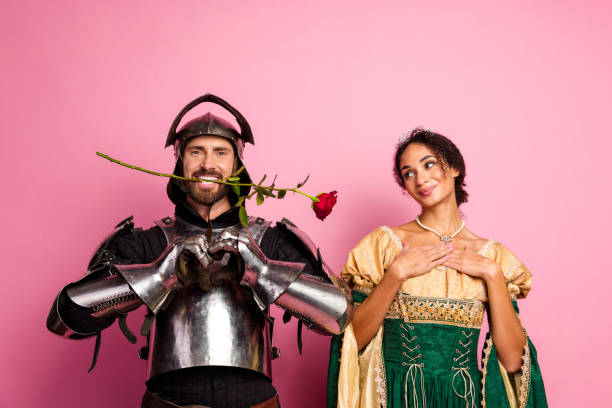 istock Romantic knight offering a rose to an elegant princess in a medieval-themed costume setting 2194074665