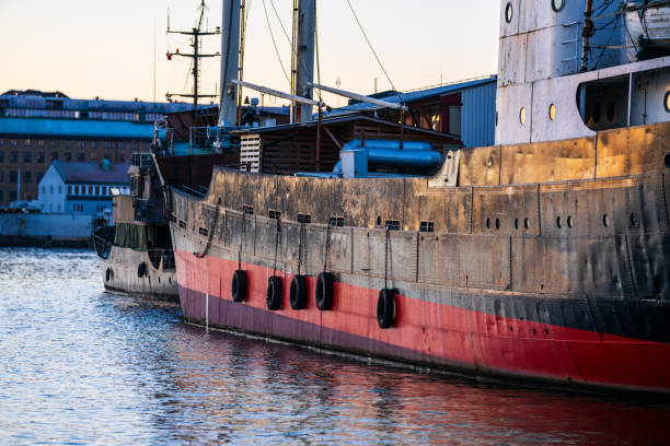 Side of a vintage freight ship at port..