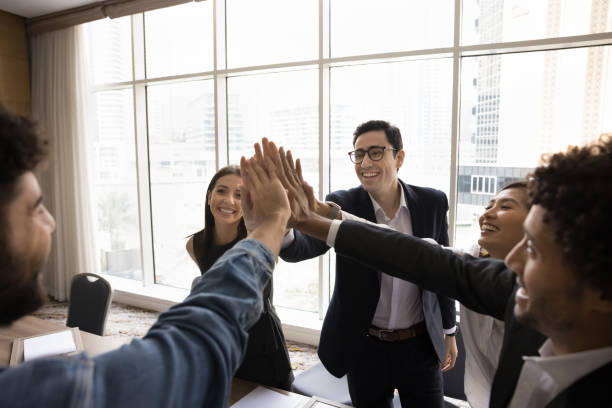 istock Multiethnic staff stack their palms together as gesture of unity 2194075546