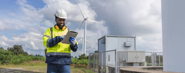 istock Survey Team Alternative energy for future. Engineers survey and checking wind turbines in sunset. Wind Turbine Renewable energy technology and sustainability. 2194076023
