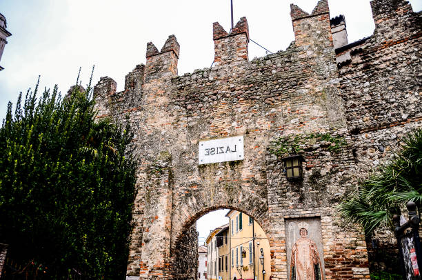 A stone archway with a white sign that reads \