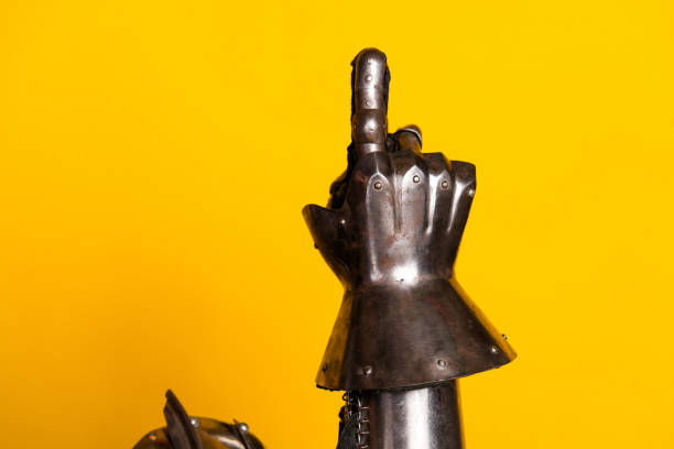 istock A knight's armored hand gesturing on a vibrant yellow background conveying medieval bravery 2194076270