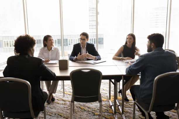 istock Young Arabian businessman dressed in suit speaking with colleagues 2194076714