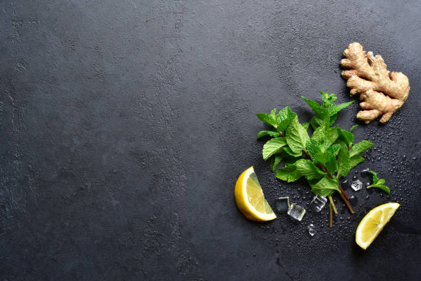 istock Ingredients for making tea, lemonade or cocktail : fresh mint, ginger, lemon. Top view with copy space. 2194077336
