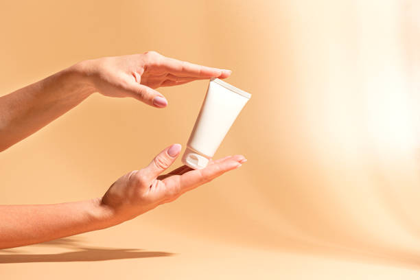 istock Female hands hold moisturizer cream. Beauty routine. 2194077494