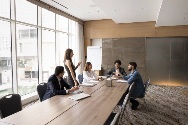 istock Multinational team exchanging opinions during briefing led by female leader 2194078191