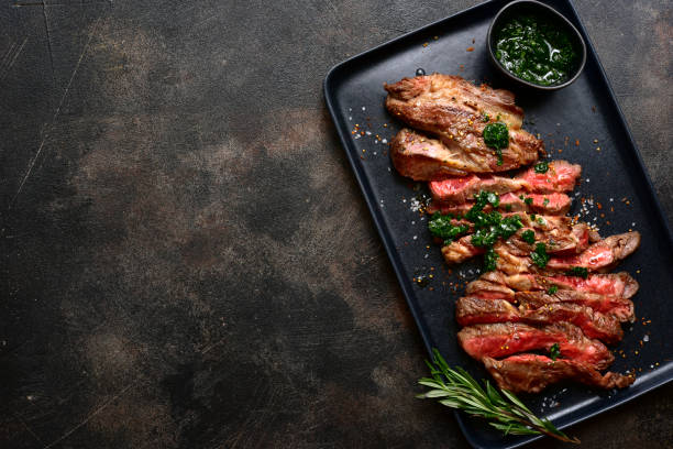 istock Grilled marbled beef steak on a black plate . Top view with copy space. 2194078409