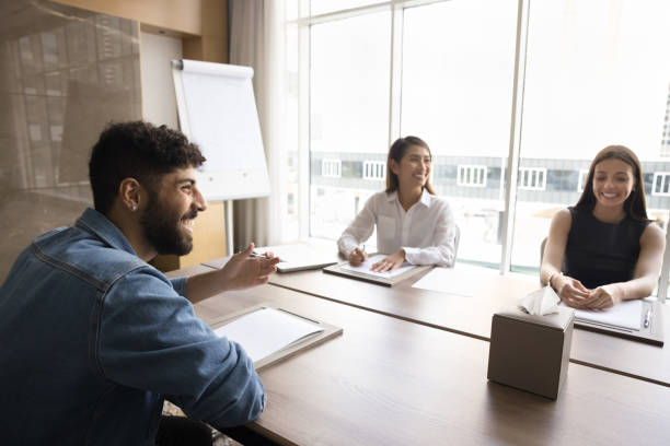 istock Group of multinational happy teammates gather in boardroom 2194078658