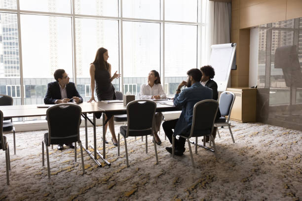 istock Attractive businesslady, trainer or business coach make speech during briefing 2194081540