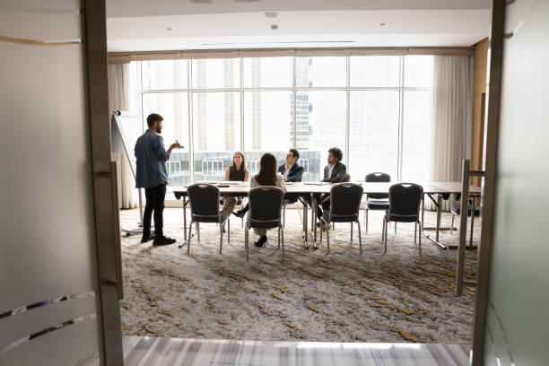 istock Young male coach performing, make flip chart presentation for staff 2194082508