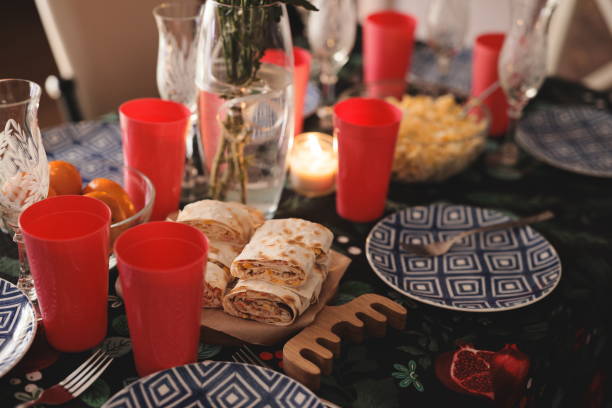 A vibrant dining setup featuring tasty wraps, festive cups, and elegant dishes for a joyful celebration.