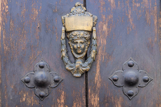 Antigua Guatemala, Sacatepequez, Guatemala. Antique brass door knocker of a woman's head.