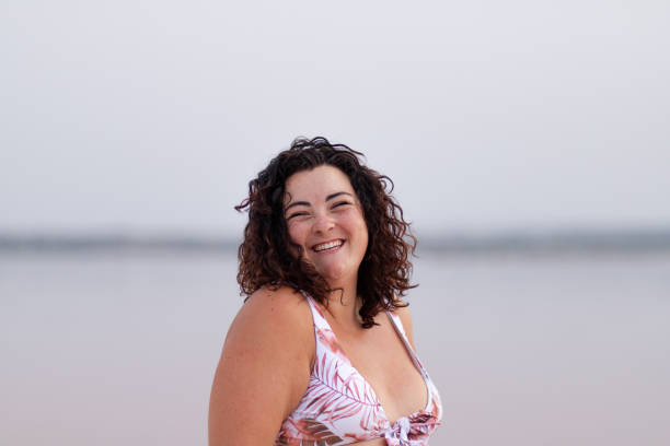 istock Cheerful curvy woman in bikini in lake 2194086695