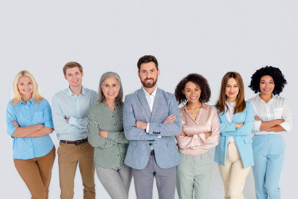 istock Diverse group of professionals standing together on a grey background, representing teamwork and collaboration in a modern workplace 2194086748