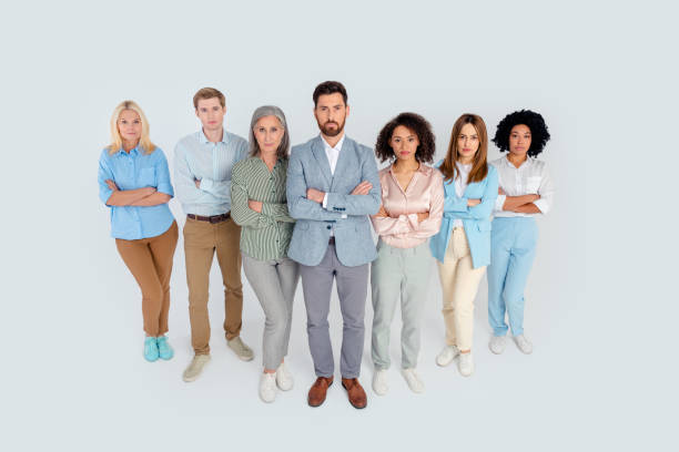 istock Diverse group of business professionals standing confidently on a grey background, symbolizing teamwork and collaboration 2194086760