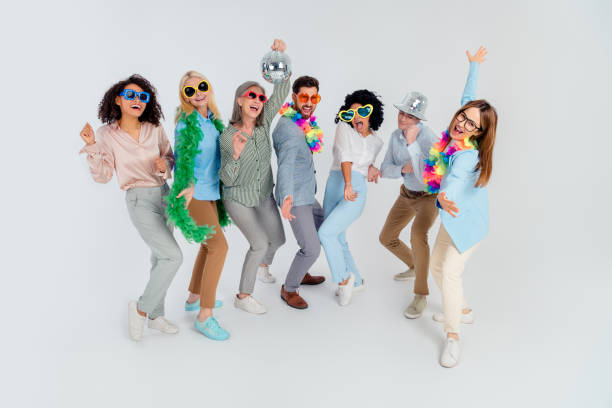 istock Group of diverse colleagues celebrating teamwork with fun props over a grey background 2194086811