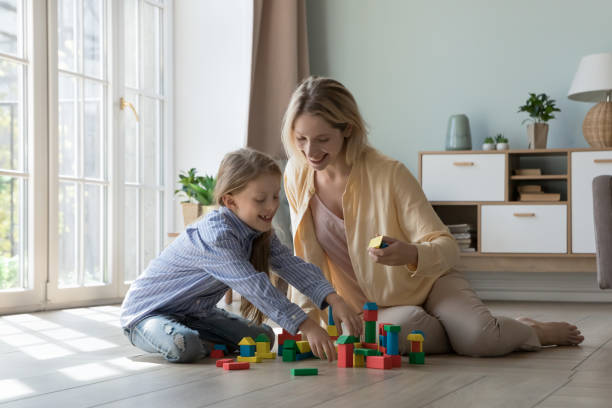 istock Cheerful excited mom and kid playing learning game at home 2194086882