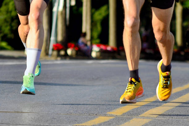 istock Pair of Marathon Runners in Mid Air 2194087130