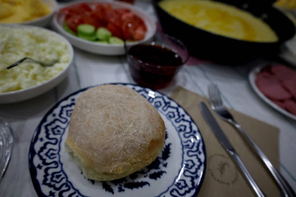Breakfast . Morning breakfast with cheese, olives, jam, tomatoes, cucumbers, butter, bread and tea