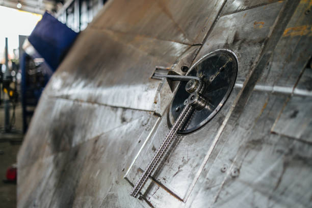 Close up shot of metallurgy worker doing metal works. Industrial interiors, Hard work jobs.