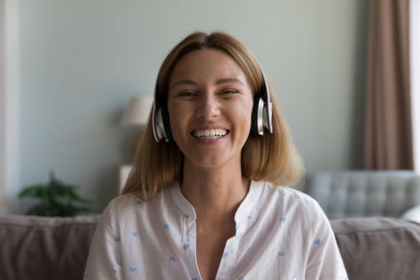 istock Cheerful happy pretty Caucasian woman wearing wireless headset head shot 2194094271