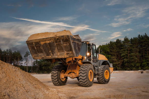 istock Wheel front loader or bulldozer at a construction site in a quarry. Powerful modern equipment for earthworks. Construction site. 2194097200