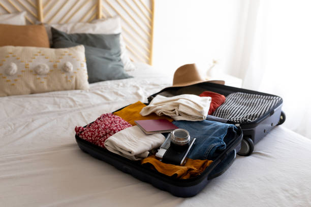 istock Suitcase open on bed with clothes and passport ready for vacation trip 2194097228
