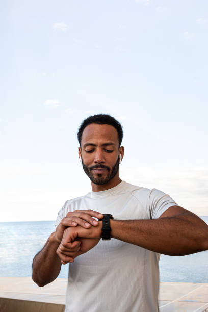 istock Young sportsman checking performance on smartwatch after training 2194097308