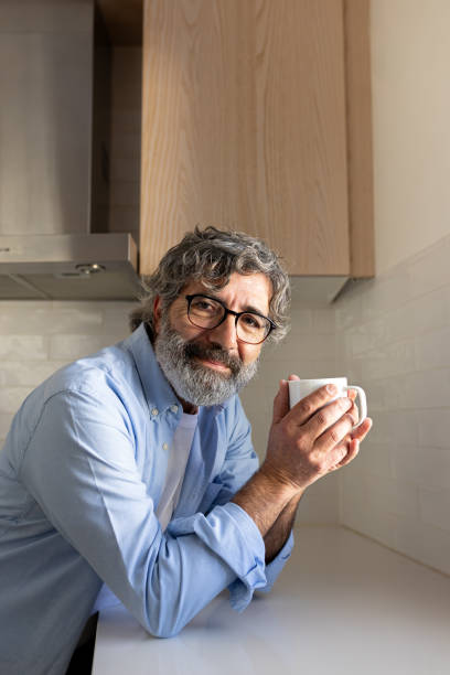 istock Mature man enjoying a cup of coffee in his modern kitchen 2194097356