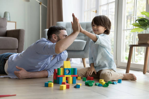istock Happy proud dad and cheerful little son boy clapping hands 2194097458