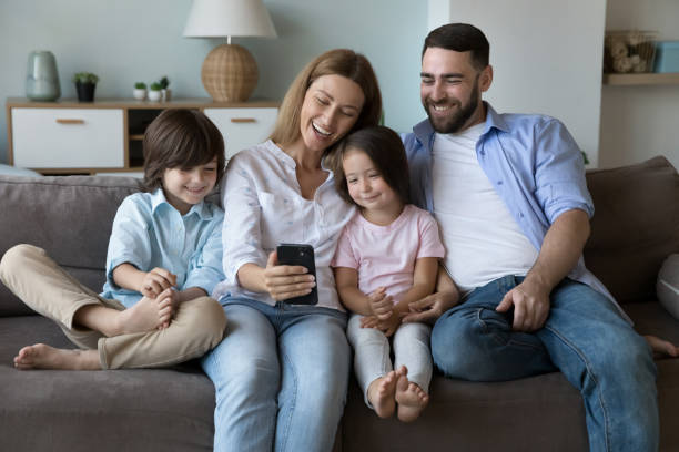 istock Happy family taking selfie on home couch 2194097962