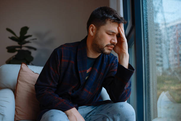 istock Young man suffering from headache, migraine or hangover at home 2194097992